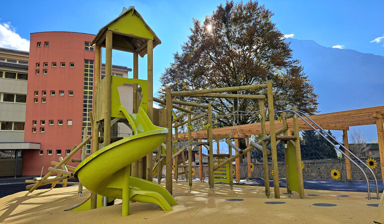 Playground equipment in front of school building